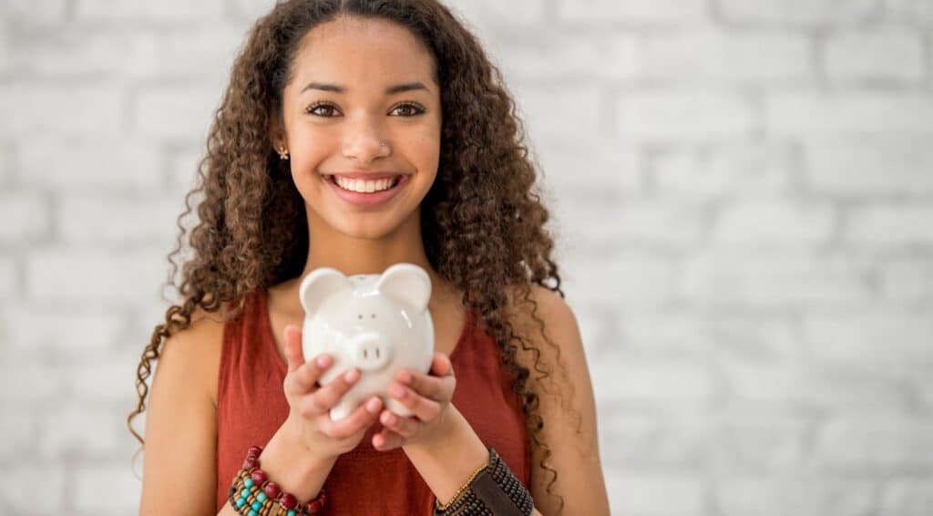 gifting money to children teen with piggybank